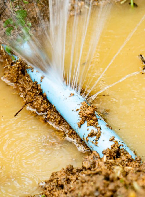 closeup of leaking water pipe at ground